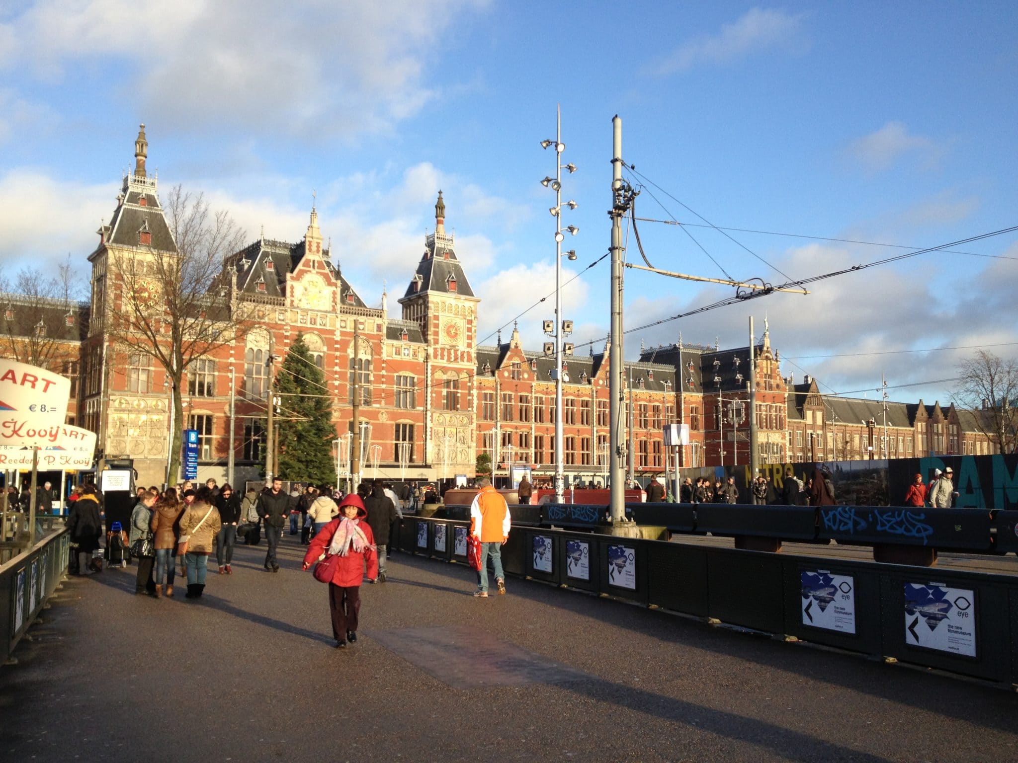 Amsterdam Centraal Bahnhof mit vilen Fußgängern davor.