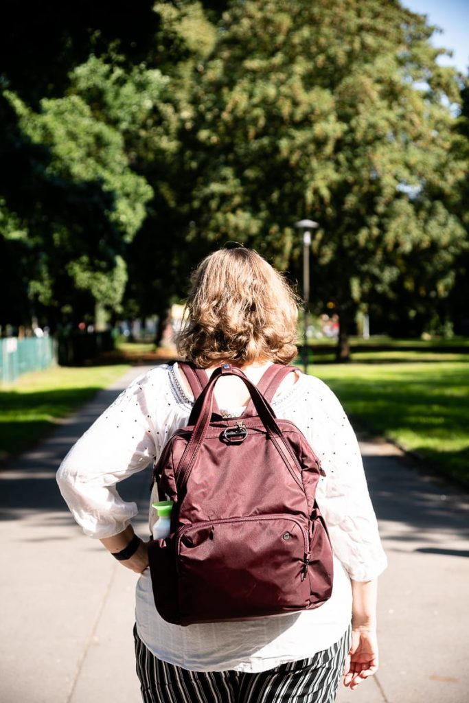 Romy Mlinzk im Westpark Dortmund unterwegs, von hinten fotografiert, pacsafe Citysafe CX auf dem Rücken.