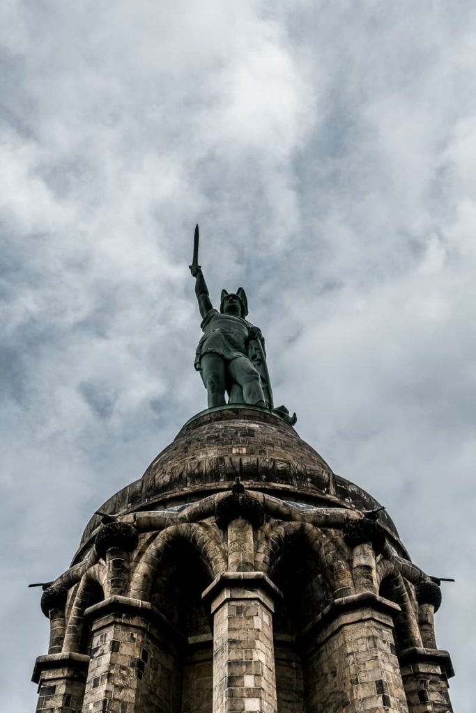 Hermannsdenkmal frontal von unten nach oben fotografiert, unheilvolle Wolken dahinter - September 2022.
